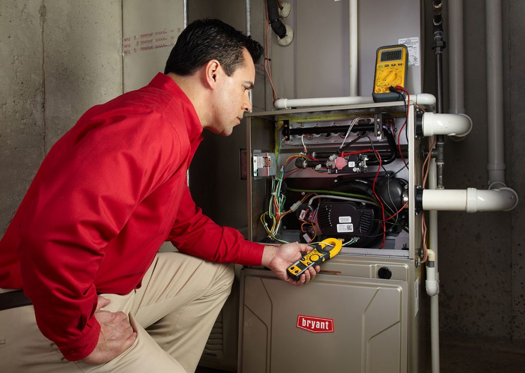 Heating technician diagnosing a furnace repair in El Monte