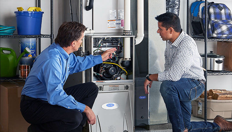 Technician evaluating a furnace for repair or replacement in El Monte