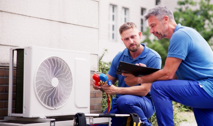 HVAC technicians installing an outdoor air conditioning unit in El Monte