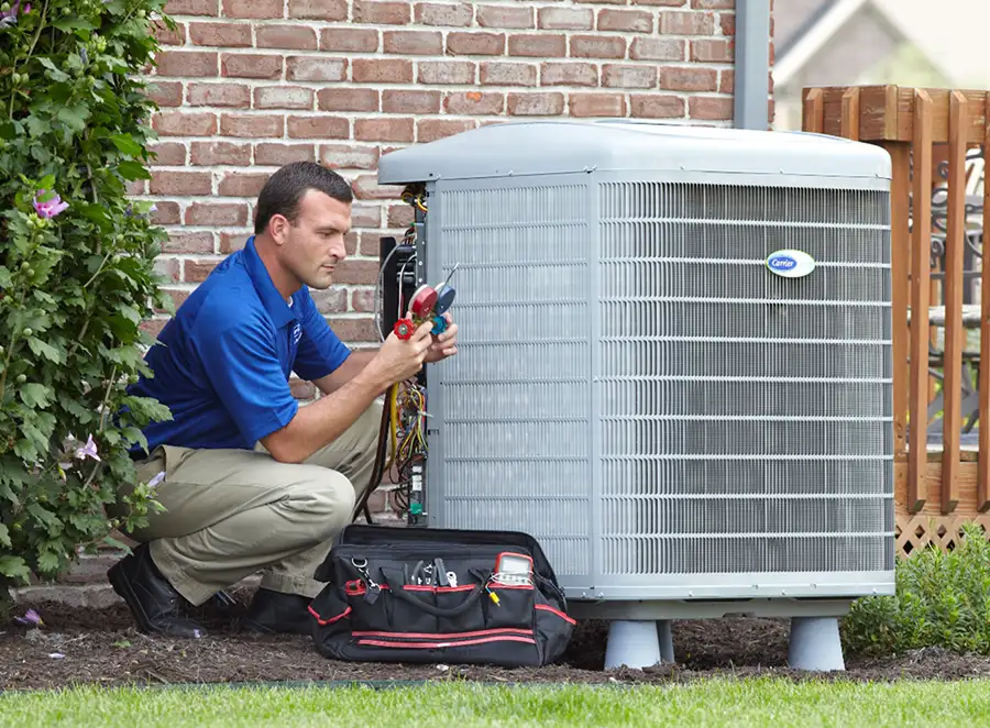 HVAC technician inspecting an outdoor AC unit in El Monte